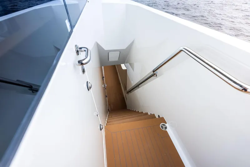 Slide: The Image of Staircase on 2017 Burger 104 Motor Yacht, leading below deck with ocean view. - 46
