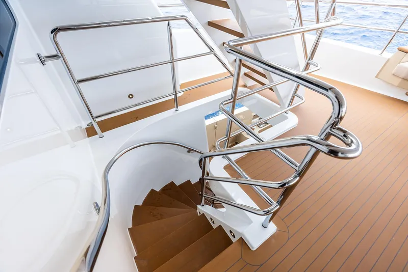 Slide: The Image of Staircase on 2017 Burger 104 Motor Yacht with sleek metal railings and wooden steps. - 49