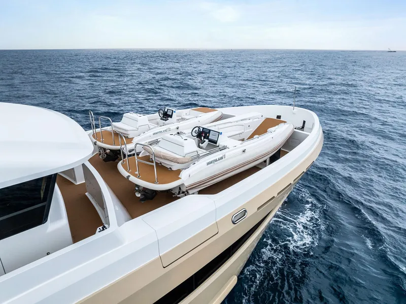 Slide: The Image of Luxurious 2017 Burger 104 Motor Yacht with tenders on deck, cruising the open sea. - 5