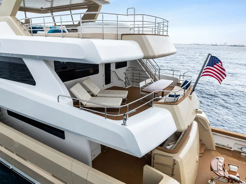 Slide: The Image of Luxurious 2017 Burger 104 Motor Yacht with spacious deck and American flag. - 9