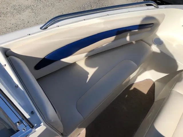Slide: The Image of 2001 Stingray 180 LS/LX boat interior with beige seating and blue accent. - 14