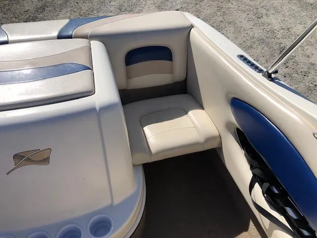 Slide: The Image of 2001 Stingray 180 LS/LX boat interior with beige and blue seating. - 17