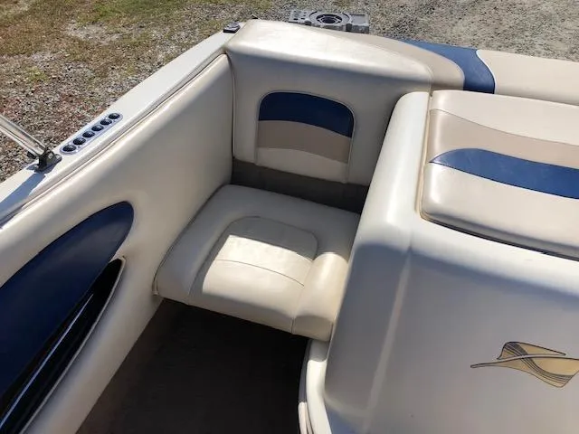 Slide: The Image of 2001 Stingray 180 LS/LX boat interior with beige and blue seating. - 18