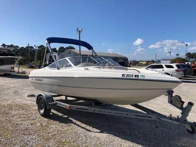 Slide: The Image of 2001 Stingray 180 LS/LX boat on trailer in sunny outdoor setting. - 2