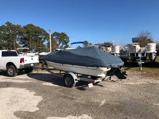 Slide: The Image of 2001 Stingray 180 LS/LX boat covered on trailer, parked outdoors. - 27
