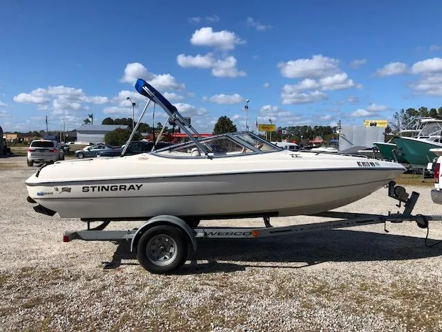 Slide: The Image of 2001 Stingray 180 LS/LX boat on trailer under blue sky. - 3