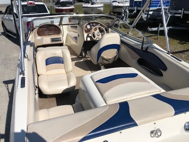 Slide: The Image of 2001 Stingray 180 LS/LX boat interior with beige and blue seating. - 7