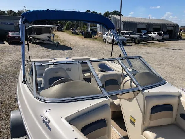 Slide: The Image of 2001 Stingray 180 LS/LX boat with blue canopy in a marina setting. - 9