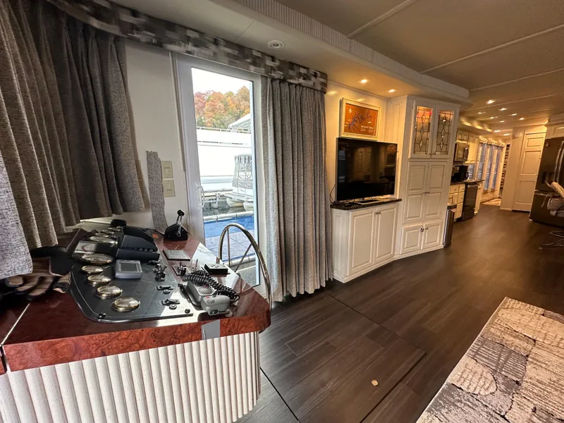 Slide: The Image of Interior of a 2001 Sharpe 16x80 houseboat with modern decor and control panel. - 16