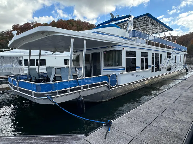Slide: The Image of 2001 Sharpe 16x80 houseboat docked on a sunny day. - 2