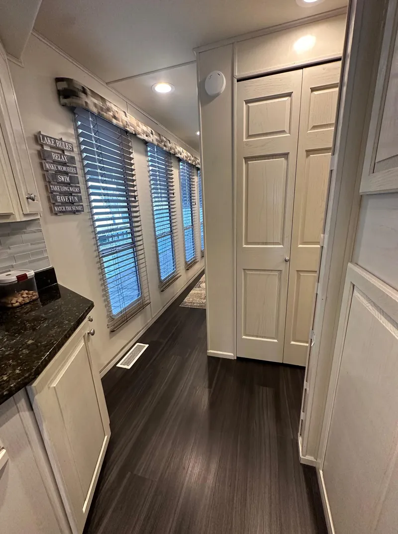 Slide: The Image of Interior of 2001 Sharpe 16x80 houseboat with modern kitchen and hallway. - 22