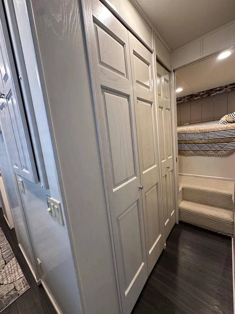 Slide: The Image of Interior of 2001 Sharpe 16x80 houseboat with white closets and bunk bed. - 31