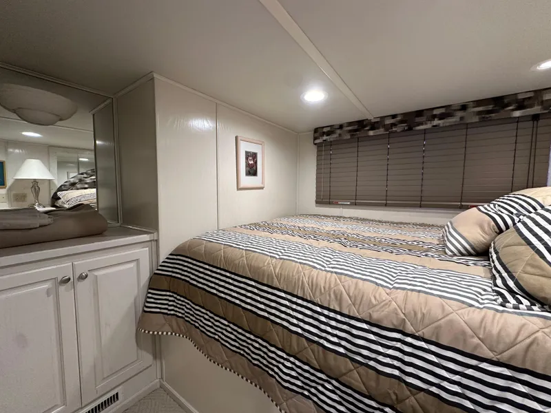 Slide: The Image of Cozy bedroom in 2001 Sharpe 16x80 houseboat with striped bedding and modern decor. - 33
