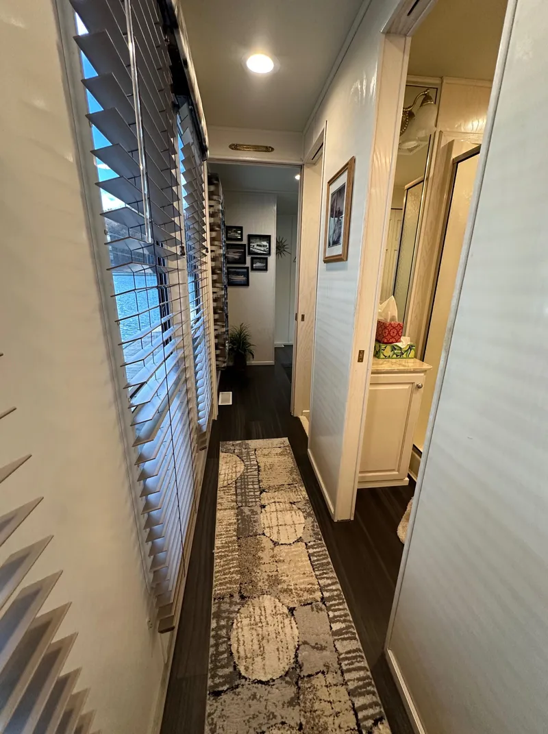Slide: The Image of Narrow hallway in 2001 Sharpe 16x80 houseboat with modern decor and natural light. - 36