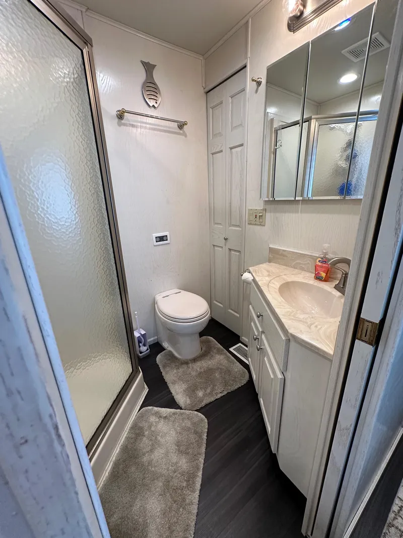 Slide: The Image of Compact bathroom in 2001 Sharpe 16x80 houseboat with shower, toilet, and vanity. - 37