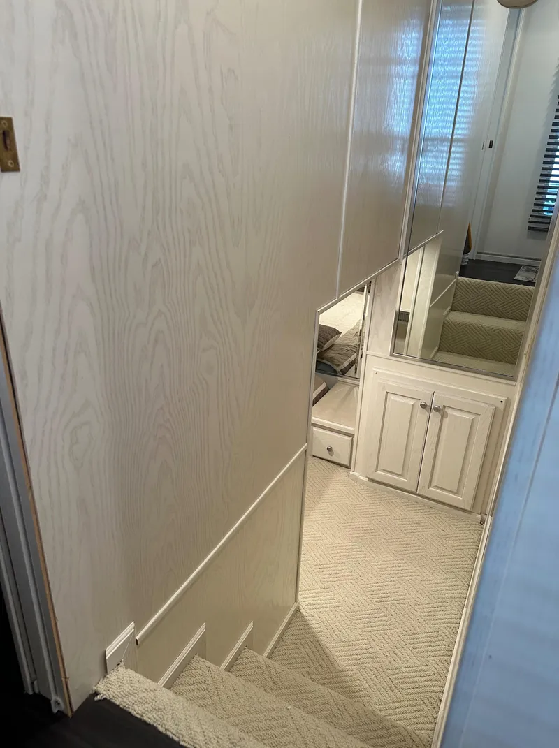 Slide: The Image of Staircase in 2001 Sharpe 16x80 houseboat with carpet and wooden paneling. - 39