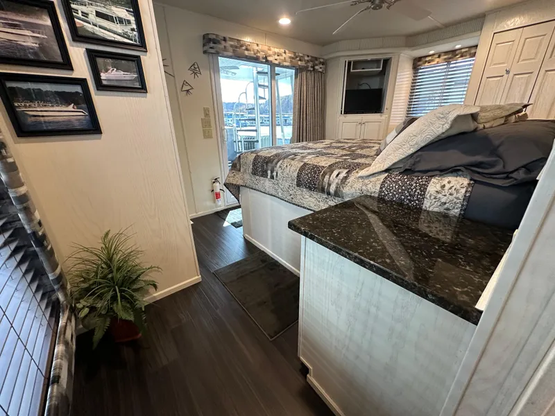 Slide: The Image of Luxurious 2001 Sharpe 16x80 houseboat bedroom with modern decor and large windows. - 43