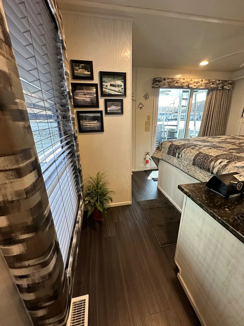 Slide: The Image of Interior of 2001 Sharpe 16x80 houseboat with modern decor and large windows. - 44