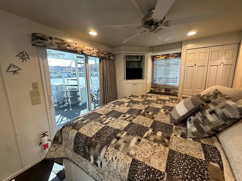 Slide: The Image of Cozy bedroom in 2001 Sharpe 16x80 houseboat with quilted bedspread and lake view. - 45