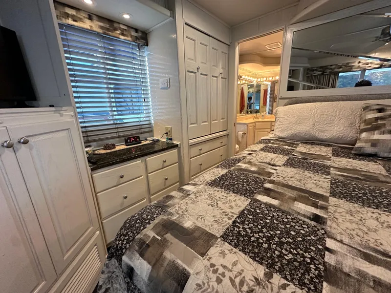 Slide: The Image of Cozy bedroom in 2001 Sharpe 16x80 houseboat with patterned bedding and ample storage. - 46