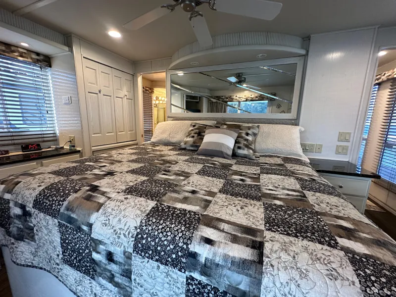 Slide: The Image of Cozy bedroom in 2001 Sharpe 16x80 houseboat with patterned quilt and large mirror. - 47