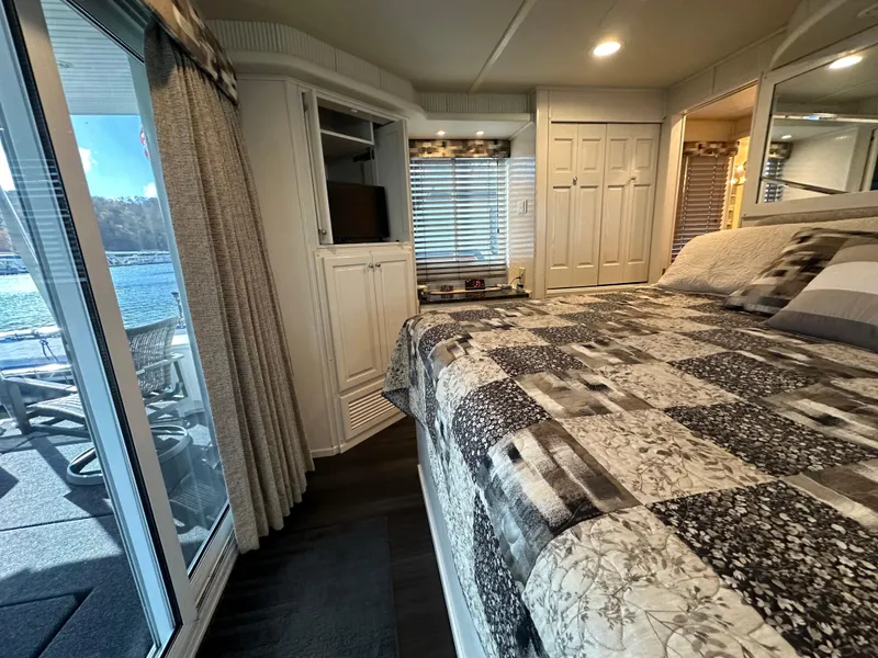 Slide: The Image of Cozy bedroom in 2001 Sharpe 16x80 houseboat with lake view and modern decor. - 48