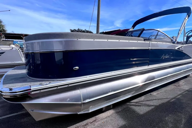 Slide: The Image of 2023 Avalon Catalina Elite Windshield pontoon boat with sleek blue and silver design. - 1