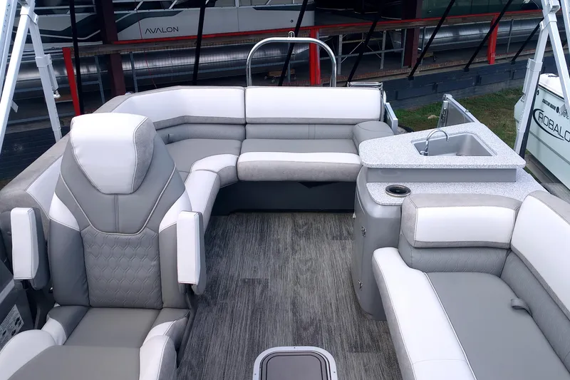 Slide: The Image of Luxurious interior of 2023 Avalon Catalina Elite Windshield boat with plush seating and sink. - 5