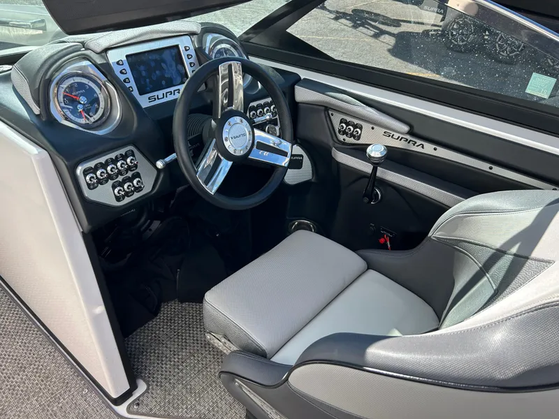 Slide: The Image of 2015 Supra SC400-550 boat interior with modern dashboard and steering wheel. - 10