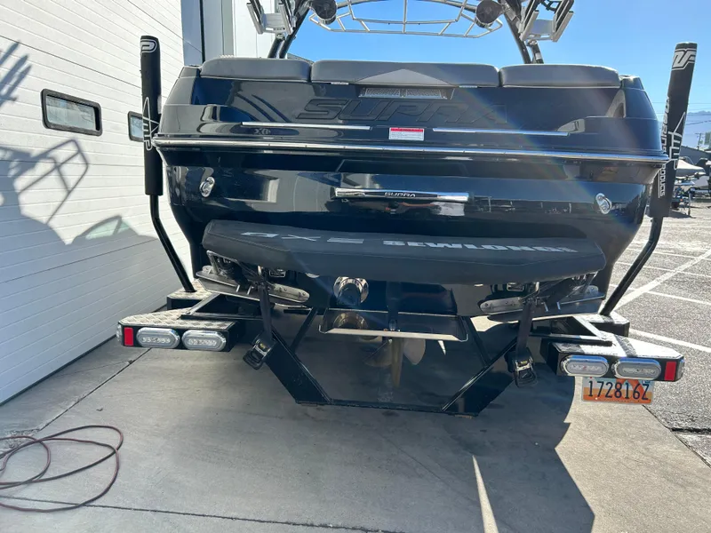 Slide: The Image of 2015 Supra SC400-550 boat, rear view, parked on concrete near a building. - 4