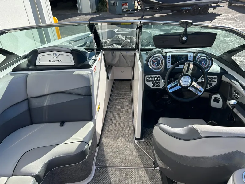 Slide: The Image of 2015 Supra SC400-550 boat interior with modern dashboard and seating. - 9