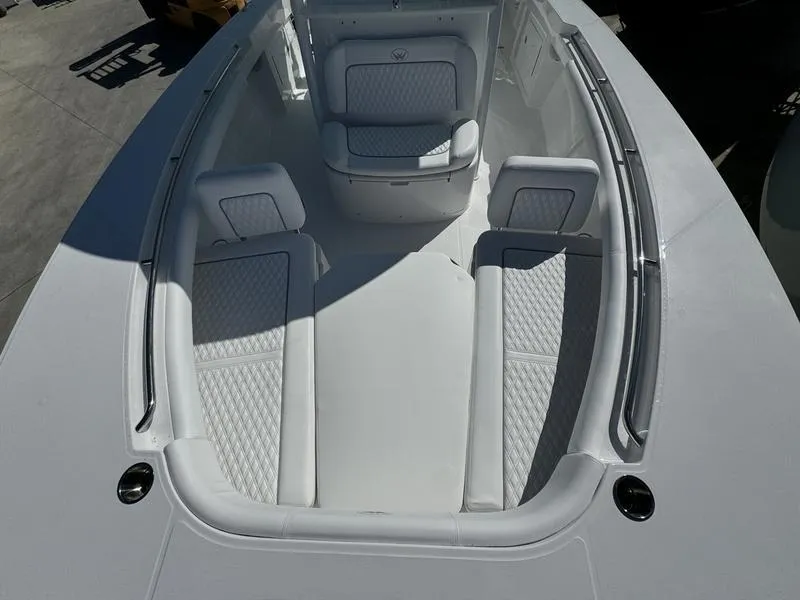 Slide: The Image of 2025 Southport 30 FE boat interior with white cushioned seating. - 11