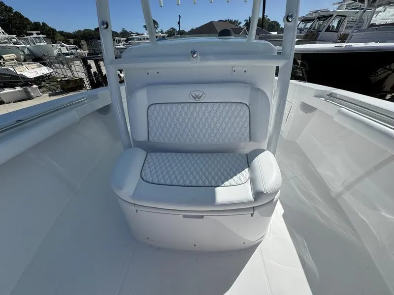 Slide: The Image of 2025 Southport 30 FE boat seating area with quilted upholstery, docked at marina. - 13