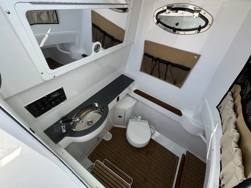 Slide: The Image of 2025 Southport 30 FE boat interior with sink, toilet, and wood flooring. - 18