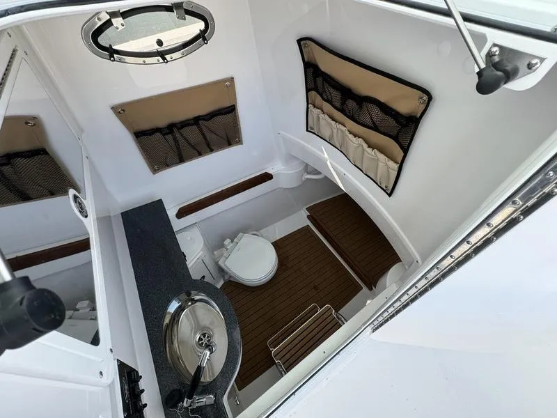 Slide: The Image of 2025 Southport 30 FE boat interior with sink, toilet, and storage compartments. - 19