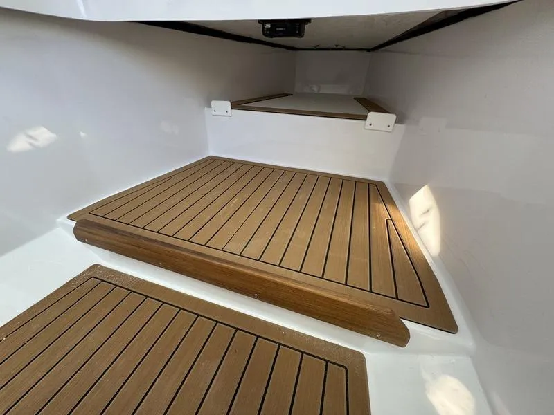 Slide: The Image of 2025 Southport 30 FE boat interior with teak flooring. - 20