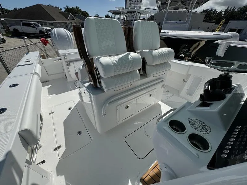 Slide: The Image of 2025 Southport 30 FE boat interior with white seating and control panel. - 22