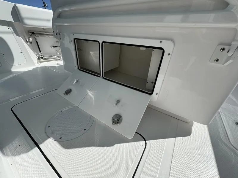 Slide: The Image of 2025 Southport 30 FE boat storage compartments with open hatches, showcasing spacious interior. - 23