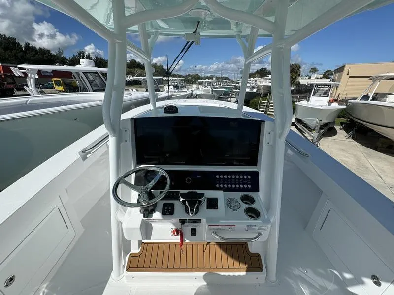 Slide: The Image of 2025 Southport 30 FE boat cockpit with modern controls and steering wheel. - 26