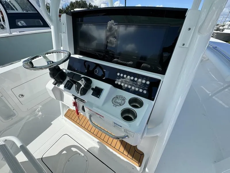 Slide: The Image of 2025 Southport 30 FE boat console with steering wheel and controls. - 27