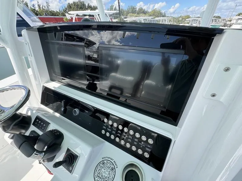 Slide: The Image of 2025 Southport 30 FE boat dashboard with modern controls and dual screens. - 28