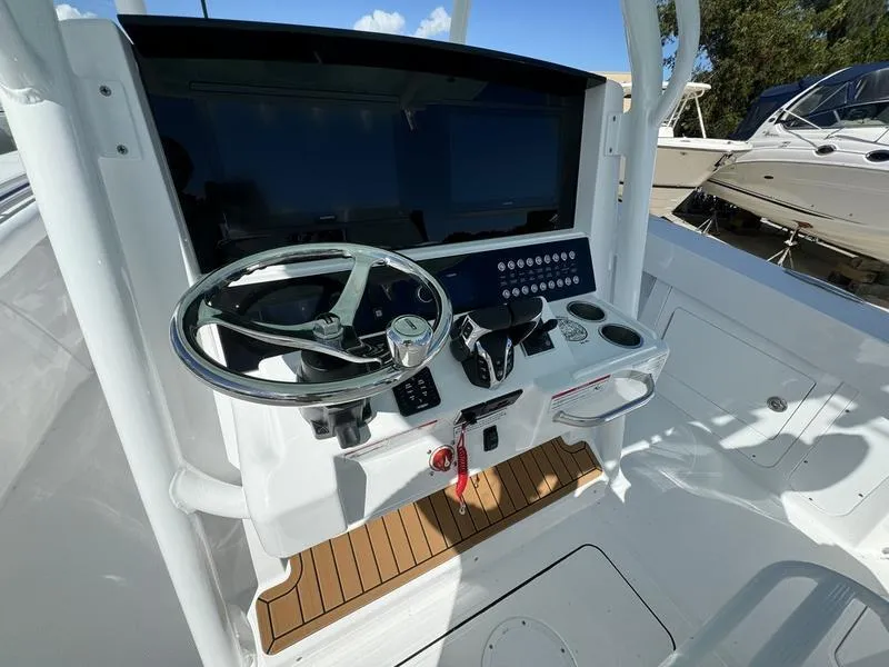 Slide: The Image of 2025 Southport 30 FE boat helm with steering wheel and control panel. - 29