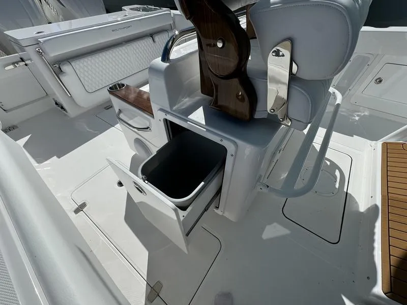 Slide: The Image of 2025 Southport 30 FE boat interior with open storage compartment and seating. - 33
