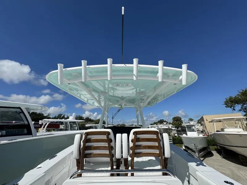 Slide: The Image of 2025 Southport 30 FE boat with sleek design and modern seating under clear blue sky. - 34