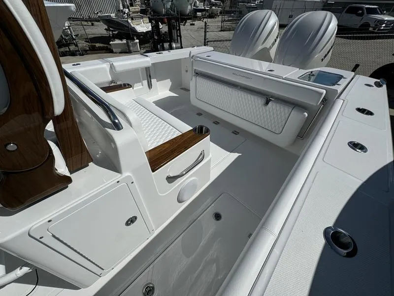 Slide: The Image of 2025 Southport 30 FE boat interior with white seating and dual engines. - 35