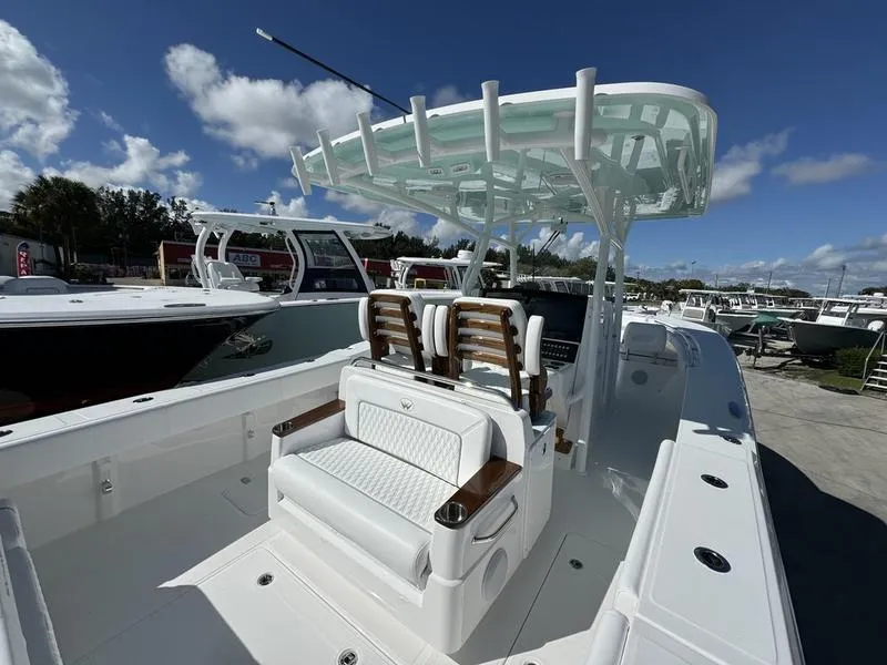 Slide: The Image of 2025 Southport 30 FE boat with sleek design and modern seating under a clear blue sky. - 37