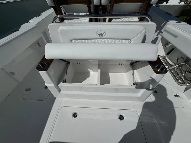 Slide: The Image of 2025 Southport 30 FE boat interior with storage compartments and seating. - 39