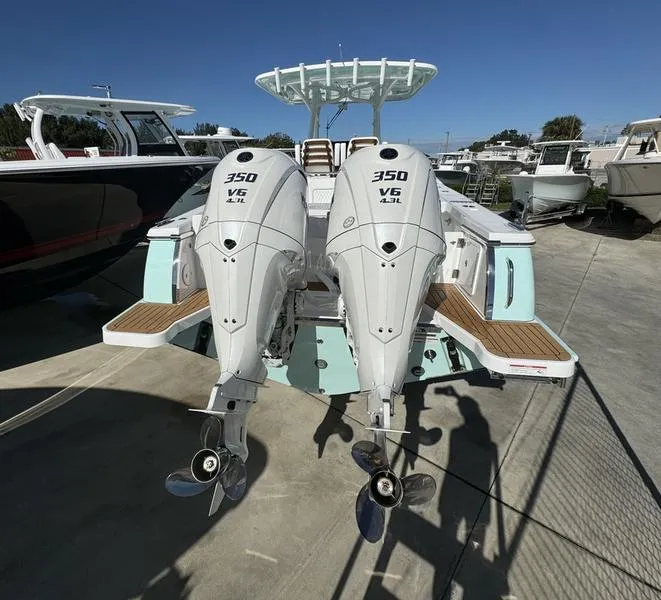 Slide: The Image of 2025 Southport 30 FE boat with dual 350 V6 engines, docked outdoors. - 4