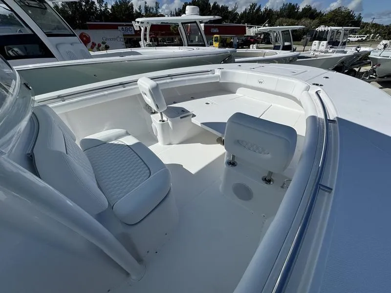 Slide: The Image of 2025 Southport 30 FE boat interior with white seating and spacious deck. - 6