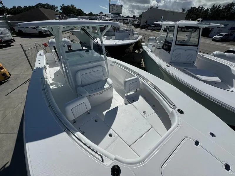 Slide: The Image of 2025 Southport 30 FE boat with spacious deck and seating, displayed at a marina. - 8